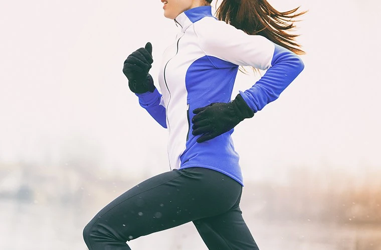 An orange painted blue, cut in half laying on a blue background